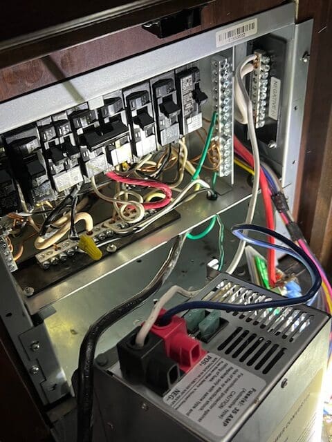 A computer board with wires and other electrical equipment.