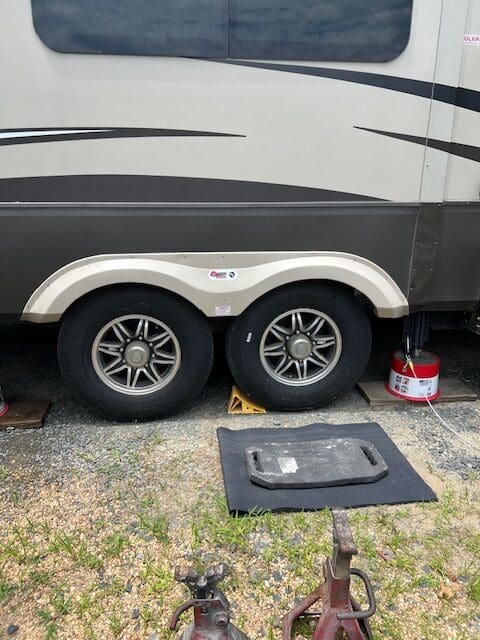 A tire on the ground near a trailer.